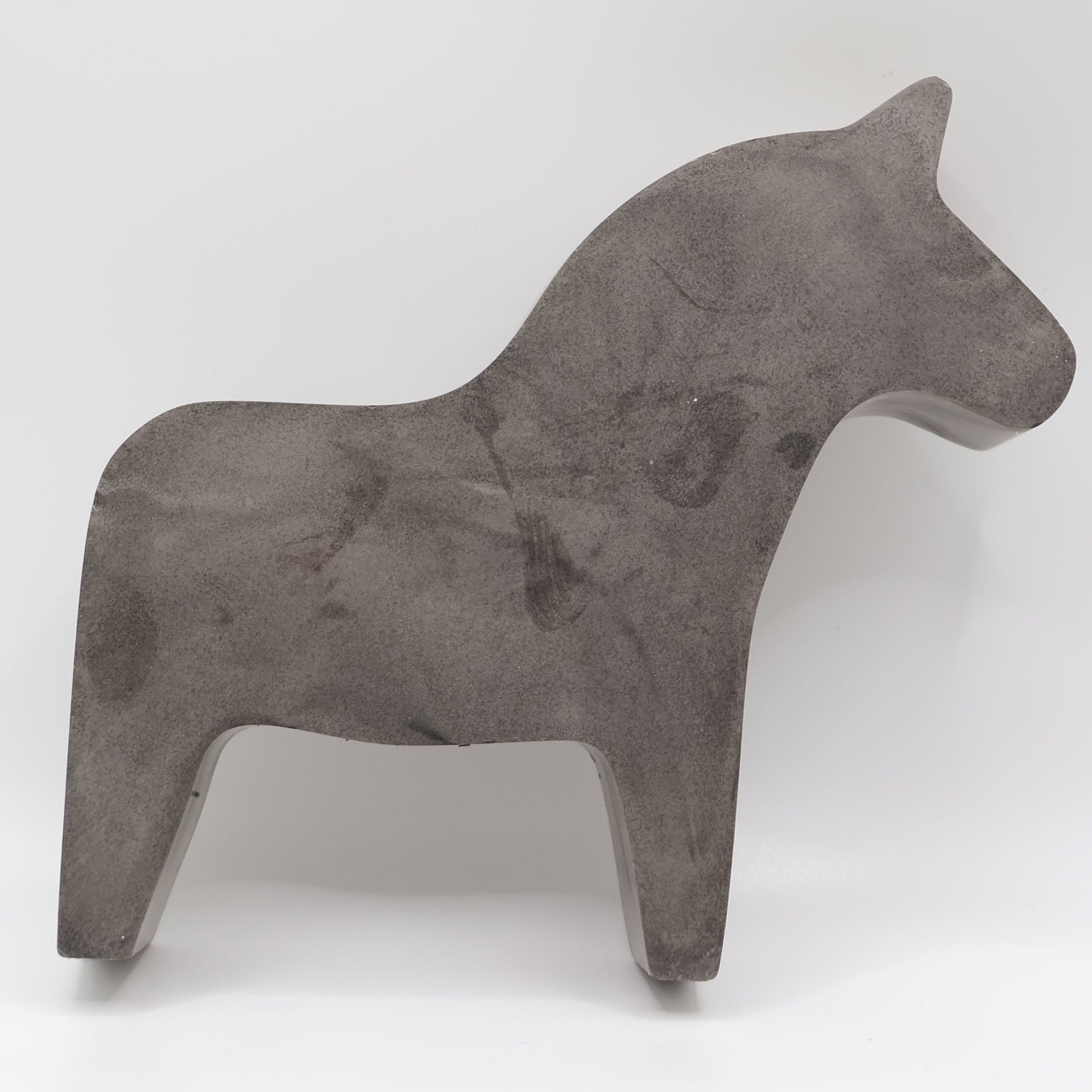 Concrete horse sculpture on a white background